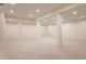 Spacious finished basement with support beams and neutral carpet and paint throughout at 7406 N Washington Blvd, Indianapolis, IN 46240