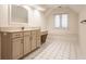Bathroom featuring vanity with marble countertop and a vanity bench with drawer storage at 7406 N Washington Blvd, Indianapolis, IN 46240