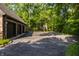 Spacious driveway leads to a three-car garage and a basketball court, perfect for outdoor activities at 7406 N Washington Blvd, Indianapolis, IN 46240