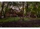 Tudor-style brick home is nestled amongst a backdrop of lush greenery and mature trees at 7406 N Washington Blvd, Indianapolis, IN 46240
