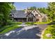 Charming Tudor home with a landscaped front yard and a circular driveway at 7406 N Washington Blvd, Indianapolis, IN 46240