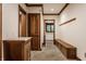 Hallway featuring wood accent and flooring, a window, bench seating, and storage at 7406 N Washington Blvd, Indianapolis, IN 46240