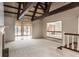 Bright and airy living room with beamed ceilings and access to an outdoor space at 7406 N Washington Blvd, Indianapolis, IN 46240