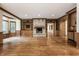 Open living room with a stone fireplace, built-in shelves, and hardwood floors at 7406 N Washington Blvd, Indianapolis, IN 46240