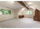 Spacious office with wood beam accents, built-in desk and shelving, and large windows at 7406 N Washington Blvd, Indianapolis, IN 46240