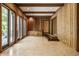 Wood-paneled sunroom features tiled floors, recessed lights, and glass doors to the backyard at 7406 N Washington Blvd, Indianapolis, IN 46240