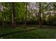 Lush greenery and mature trees define the landscape surrounding this property at 7406 N Washington Blvd, Indianapolis, IN 46240