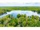 Stunning aerial view of the property with lake access and mature trees surrounding the home at 7595 Heather Dr, Nineveh, IN 46164