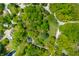 Aerial view of the property showcasing the landscaped lot, mature trees and driveway at 7595 Heather Dr, Nineveh, IN 46164
