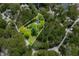 Aerial view of the property showcasing the landscaped lot, mature trees and driveway at 7595 Heather Dr, Nineveh, IN 46164