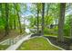 Stairway leading to backyard with lake views and mature trees at 7595 Heather Dr, Nineveh, IN 46164