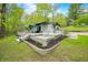 The property offers a spacious back deck ideal for relaxation and entertaining, with garden swing and seating at 7595 Heather Dr, Nineveh, IN 46164