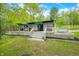 A backyard deck with outdoor seating is perfect for entertaining or relaxing with natural green surroundings at 7595 Heather Dr, Nineveh, IN 46164