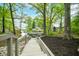 Stairway leading to backyard with lake views and mature trees at 7595 Heather Dr, Nineveh, IN 46164