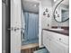 Well-lit bathroom with vanity, mirror, and shower with blue curtain at 7595 Heather Dr, Nineveh, IN 46164