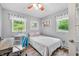 Bedroom features a bed, desk, chair and two windows providing natural light at 7595 Heather Dr, Nineveh, IN 46164