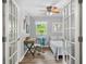 A bedroom with desk and natural light from the surrounding green landscape at 7595 Heather Dr, Nineveh, IN 46164
