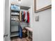 Well-organized walk-in closet with custom shelving, ample storage, and a cozy bench for added convenience at 7595 Heather Dr, Nineveh, IN 46164
