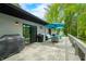 Inviting deck area with grill, stylish seating, and a light blue umbrella perfect for outdoor enjoyment at 7595 Heather Dr, Nineveh, IN 46164