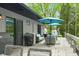 Inviting deck area with grill, stylish seating, and a light blue umbrella perfect for outdoor enjoyment at 7595 Heather Dr, Nineveh, IN 46164