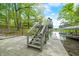 View of a wooden dock with stairs leading down to the water and a boat dock with covered slip at 7595 Heather Dr, Nineveh, IN 46164