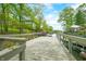 Spacious dock with a wooden deck and railing, leading to a covered boat slip and water access at 7595 Heather Dr, Nineveh, IN 46164