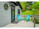Charming exterior with a round window and teal Adirondack chairs at 7595 Heather Dr, Nineveh, IN 46164