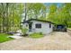 Exterior of this delightful home featuring an adjacent covered parking area, small deck, and lawn at 7595 Heather Dr, Nineveh, IN 46164