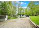 Charming home featuring a stone driveway, attached carport, well-kept lawn, and mature trees at 7595 Heather Dr, Nineveh, IN 46164
