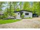 The home has a charming exterior with a small deck and an adjacent covered parking area at 7595 Heather Dr, Nineveh, IN 46164