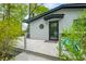 Charming exterior with a round window, black door, and teal chair on the porch at 7595 Heather Dr, Nineveh, IN 46164