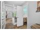 A hallway showing the seamless transition between rooms, with a view to a bathroom at 7595 Heather Dr, Nineveh, IN 46164