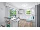 Bright kitchen with white cabinetry, stainless steel appliances, wood floors, and sliding glass door to the outside at 7595 Heather Dr, Nineveh, IN 46164