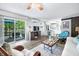 Open living space features wood floors, comfortable furniture, and sliding doors to the deck at 7595 Heather Dr, Nineveh, IN 46164