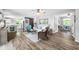 Open-concept living space with wood floors seamlessly connects the living room and kitchen, bathed in natural light at 7595 Heather Dr, Nineveh, IN 46164