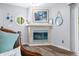 Living room corner with a fireplace, round mirror, and stylish decor at 7595 Heather Dr, Nineveh, IN 46164