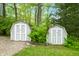 Two small sheds with light gray siding and white doors provide ample outdoor storage on the property at 7595 Heather Dr, Nineveh, IN 46164