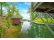 Scenic water view showcasing a tranquil cove with lush greenery and covered boat slips at 7595 Heather Dr, Nineveh, IN 46164