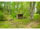 A quaint woodshed filled with neatly stacked logs surrounded by a verdant, wooded landscape at 7595 Heather Dr, Nineveh, IN 46164