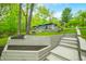 Landscaped retaining walls leading to a house, outdoor living space, and large trees at 7595 Heather Dr, Nineveh, IN 46164