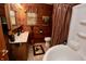 Cozy bathroom featuring wood paneling, a vintage-style tub, and rustic decor at 76 Manhattan Ave, Indianapolis, IN 46241