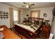 Comfortable bedroom with a wooden bed frame, patterned quilt, and traditional decor at 76 Manhattan Ave, Indianapolis, IN 46241