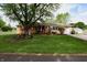 Charming brick home with a lush green lawn and mature trees, perfect for outdoor enjoyment at 76 Manhattan Ave, Indianapolis, IN 46241