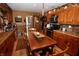 Kitchen with stainless steel appliances, wooden cabinets, and a cozy dining table for meals at 76 Manhattan Ave, Indianapolis, IN 46241