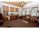 Cozy sunroom with wood-paneled ceiling, neutral carpet, and plentiful natural light from large windows at 76 Manhattan Ave, Indianapolis, IN 46241