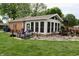 Cozy sunroom addition, showing the exterior wall of windows overlooking the backyard at 76 Manhattan Ave, Indianapolis, IN 46241