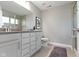 Bathroom with dual sinks, framed mirror, and glass shower door at 8245 Bostic Dr, Fishers, IN 46038