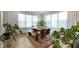 Bright dining room with large windows, a wood table, and indoor plants at 8245 Bostic Dr, Fishers, IN 46038