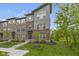 Modern townhome showcasing a stylish brick and siding facade, professional landscaping, and inviting entrance at 8245 Bostic Dr, Fishers, IN 46038