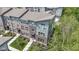 Aerial view of modern townhome showcasing brick and siding facade, professional landscaping, and inviting entrance at 8245 Bostic Dr, Fishers, IN 46038